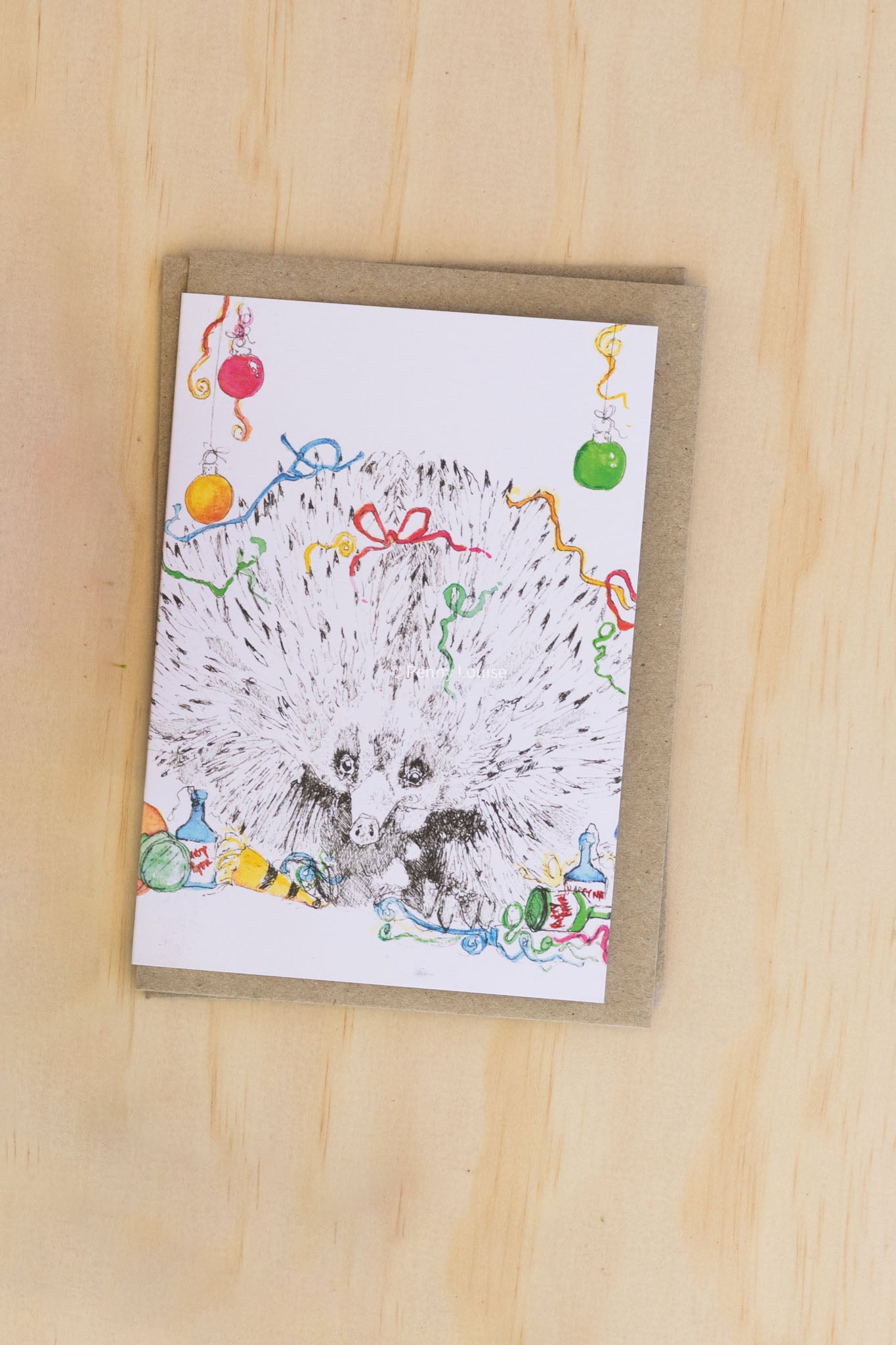 Card with an echidna illustration on a wooden surface