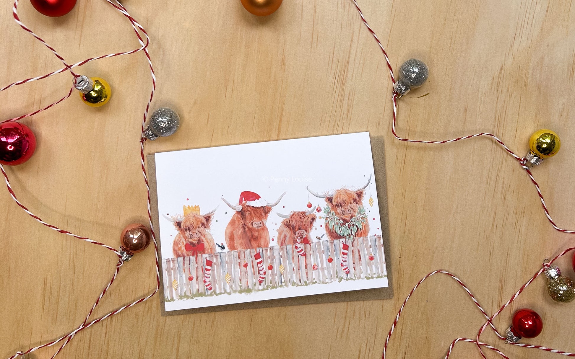 Christmas greeting card with four highland cows and two wrens dressed for a festive Christmas 